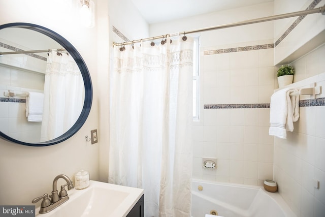 full bath with a sink and shower / bath combo with shower curtain