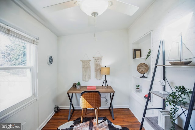 office space featuring baseboards, ceiling fan, and wood finished floors