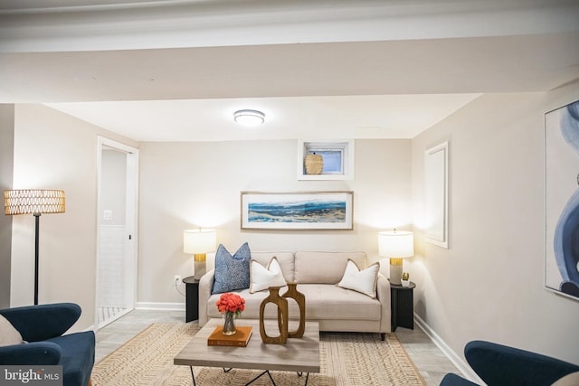 living room featuring baseboards and light wood-style flooring
