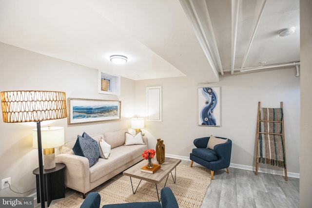 living room with baseboards and light wood-style flooring