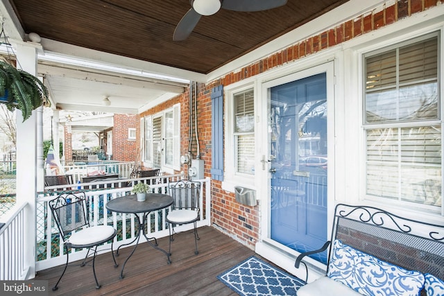 wooden terrace with a porch and ceiling fan
