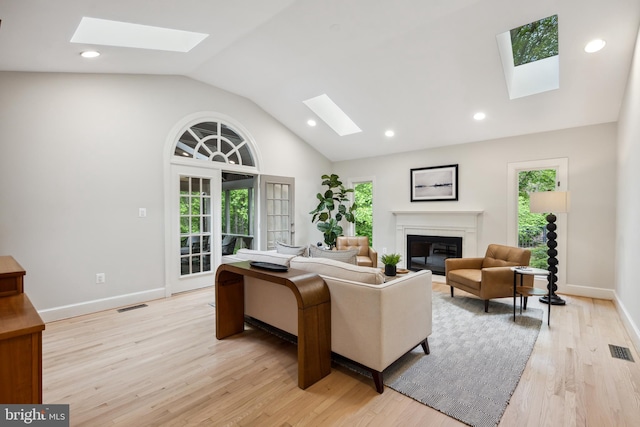 6530 Heather Brook Ct, Mclean, VA 22101 - living area featuring visible vents, a glass covered fireplace, and a healthy amount of sunlight