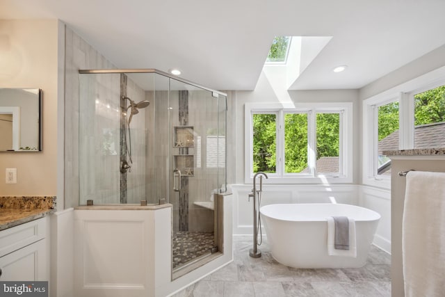 6530 Heather Brook Ct, Mclean, VA 22101 - full bathroom with vanity, a stall shower, a skylight, and a soaking tub