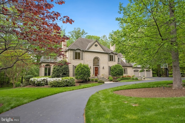 6530 Heather Brook Ct, Mclean, VA 22101 - view of front of home with curved driveway, a chimney, and a front yard