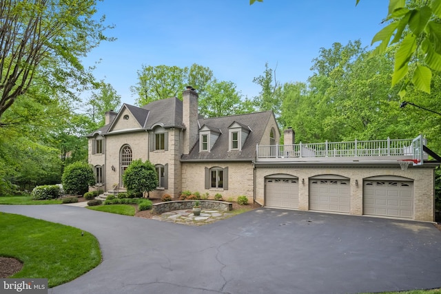 6530 Heather Brook Ct, Mclean, VA 22101 - french country inspired facade featuring a chimney, aphalt driveway, brick siding, and a balcony