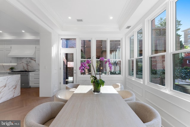 sunroom / solarium with crown molding, recessed lighting, a tray ceiling, and visible vents
