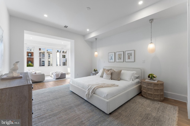 bedroom with recessed lighting, baseboards, and wood finished floors