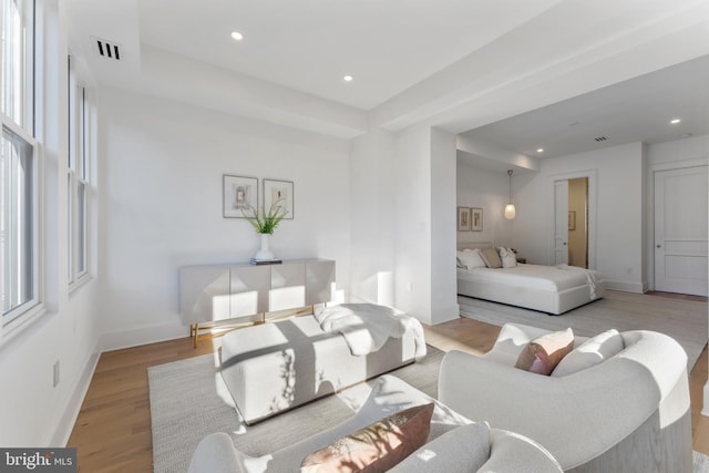 bedroom featuring baseboards, recessed lighting, wood finished floors, and visible vents
