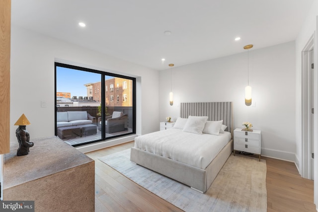bedroom with recessed lighting, light wood finished floors, and access to exterior