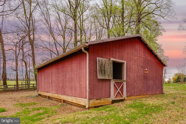 outdoor structure at dusk featuring an outbuilding