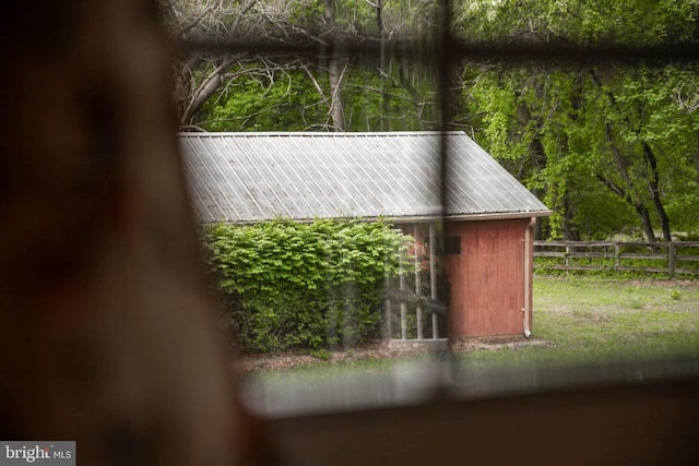 view of outbuilding featuring fence