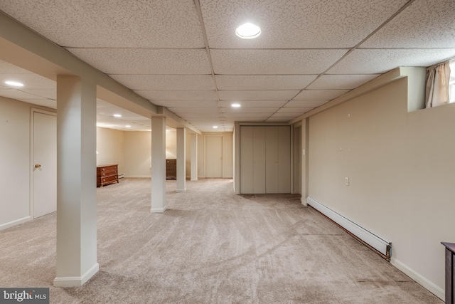 finished below grade area with a baseboard radiator, carpet floors, a paneled ceiling, recessed lighting, and baseboards