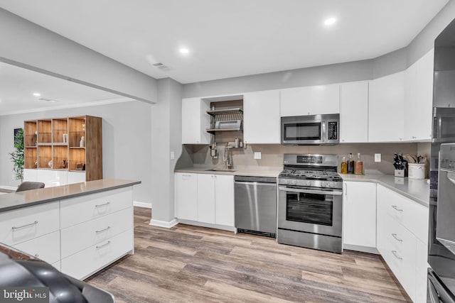 kitchen featuring recessed lighting, stainless steel appliances, open shelves, visible vents, and white cabinetry