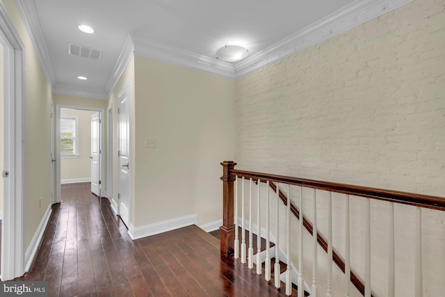 corridor featuring dark wood-style floors, brick wall, an upstairs landing, visible vents, and baseboards