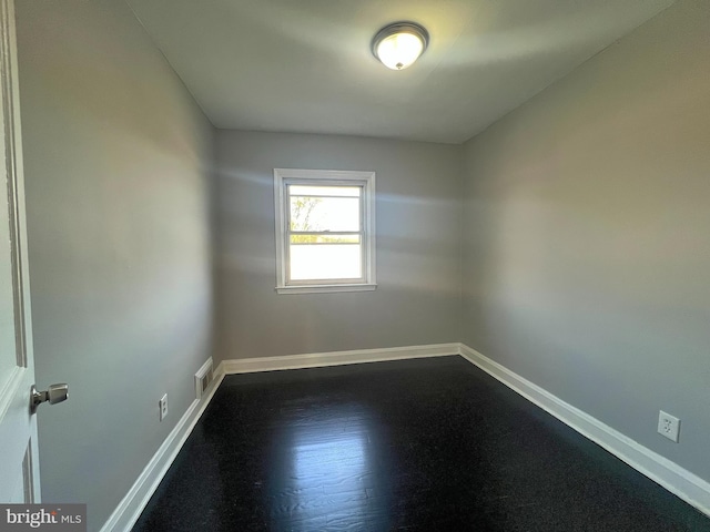 spare room featuring baseboards