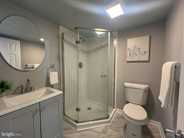 full bath featuring a shower stall, marble finish floor, vanity, and toilet