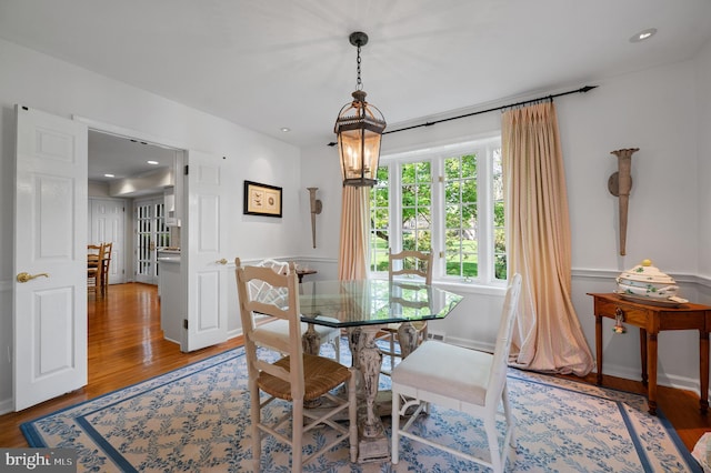 dining area with wood finished floors and recessed lighting