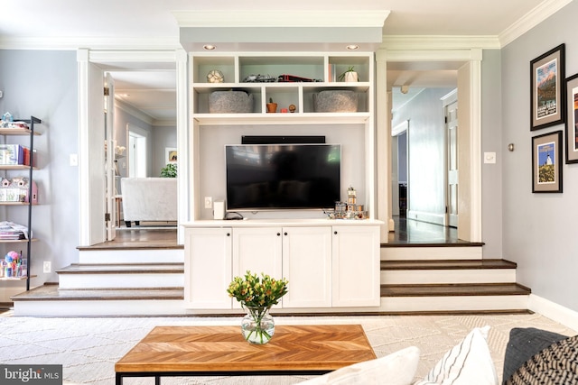 living area with baseboards, ornamental molding, and stairway