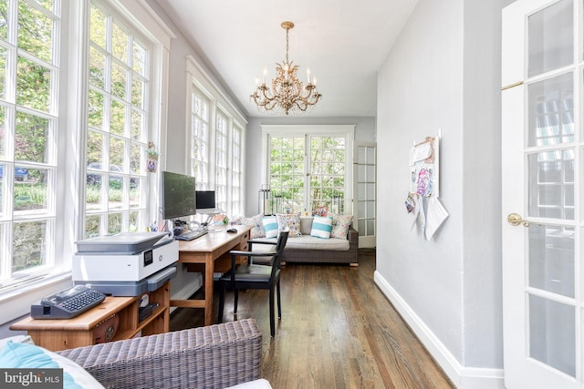 office featuring baseboards, an inviting chandelier, and hardwood / wood-style flooring
