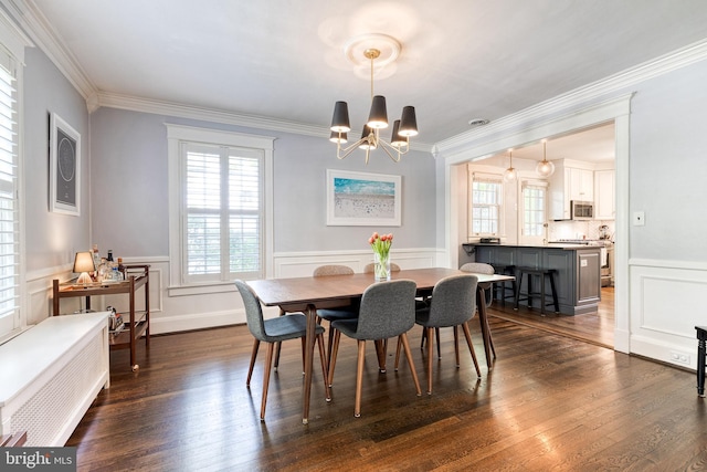 dining area with a notable chandelier, plenty of natural light, and ornamental molding