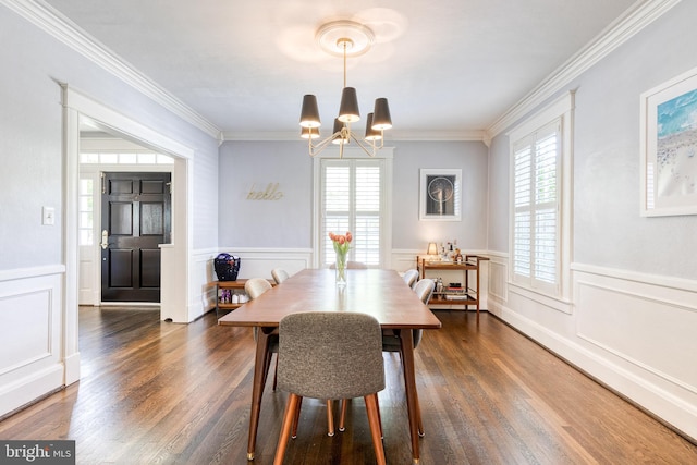dining area featuring an inviting chandelier, plenty of natural light, and ornamental molding