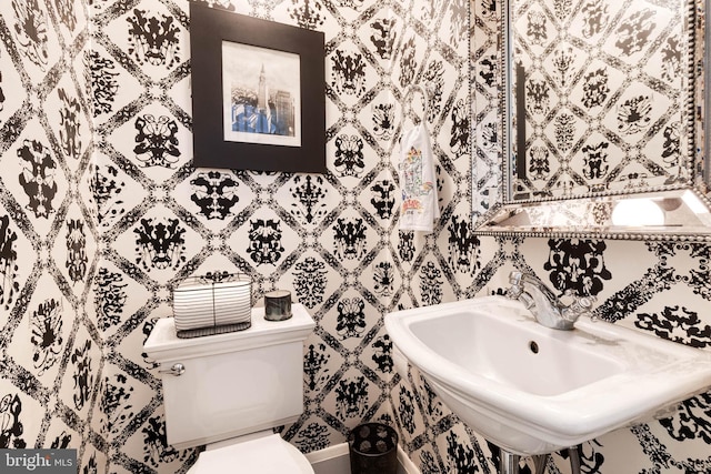 half bathroom featuring a sink and toilet