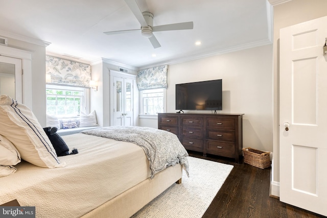 bedroom with crown molding, a ceiling fan, dark wood-style flooring, and visible vents