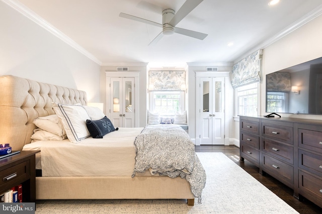 bedroom featuring ornamental molding, french doors, dark wood finished floors, and visible vents