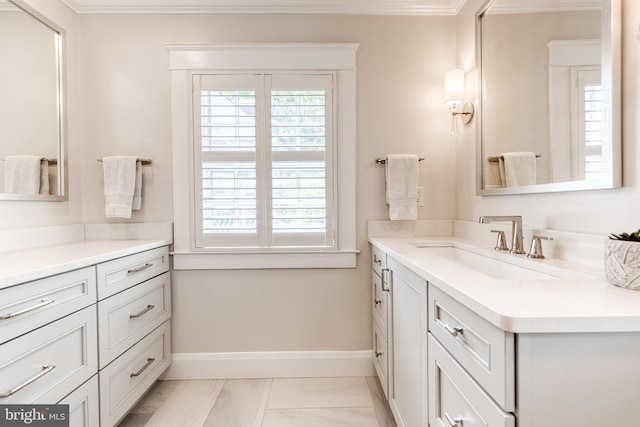 bathroom featuring crown molding, vanity, baseboards, and marble finish floor