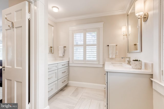full bath featuring vanity, ornamental molding, baseboards, and marble finish floor