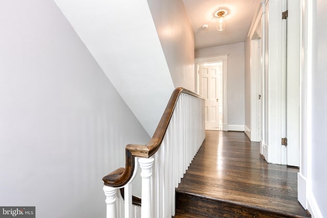 stairway featuring baseboards and wood finished floors