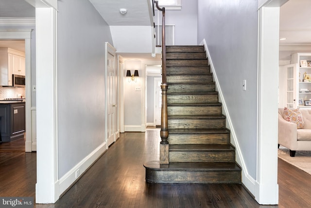stairs with baseboards and wood finished floors
