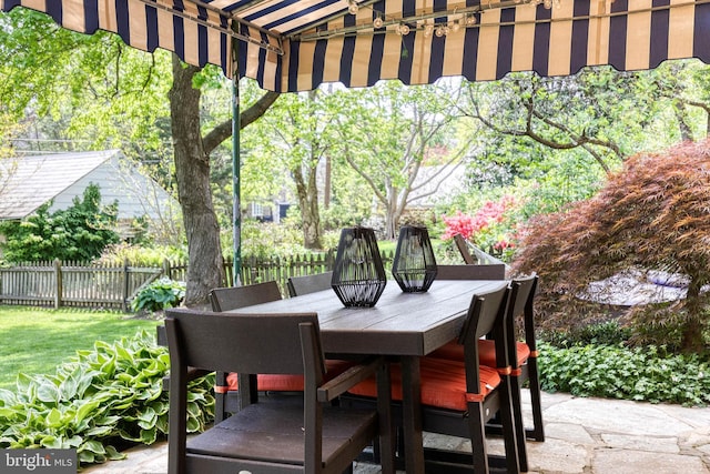 view of patio with fence and outdoor dining space
