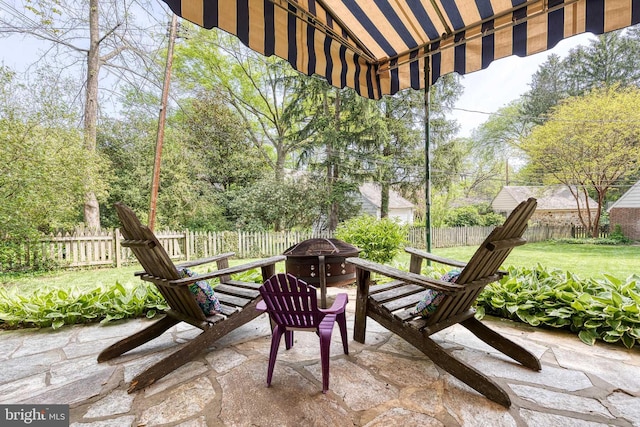 view of patio with fence and an outdoor fire pit