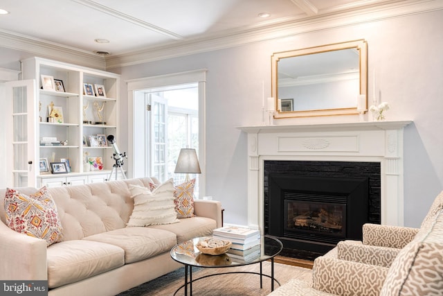 living area with crown molding, recessed lighting, a fireplace with flush hearth, and wood finished floors