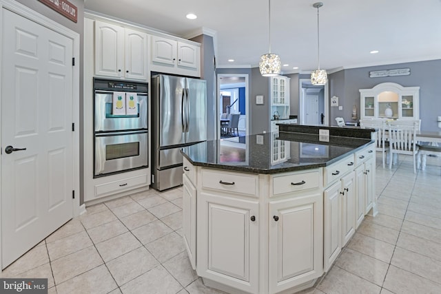 kitchen featuring crown molding, hanging light fixtures, a center island, stainless steel appliances, and light tile patterned floors