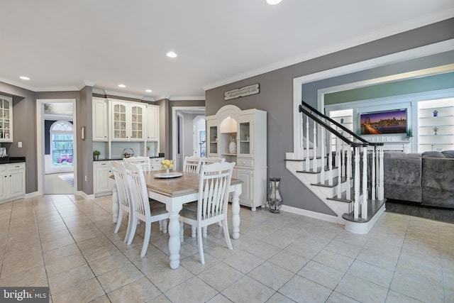dining area with baseboards, ornamental molding, recessed lighting, and light tile patterned flooring