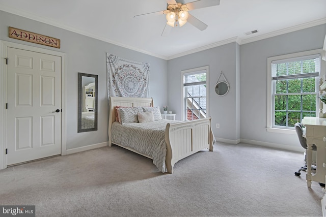 carpeted bedroom featuring crown molding, baseboards, ceiling fan, and visible vents