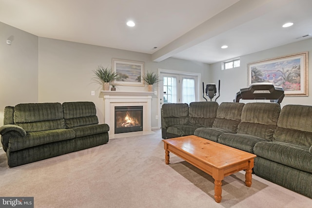 carpeted living area featuring visible vents, recessed lighting, a fireplace with flush hearth, and beamed ceiling