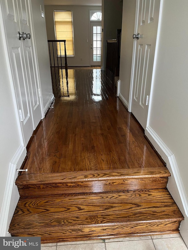 hall with wood finished floors and baseboards