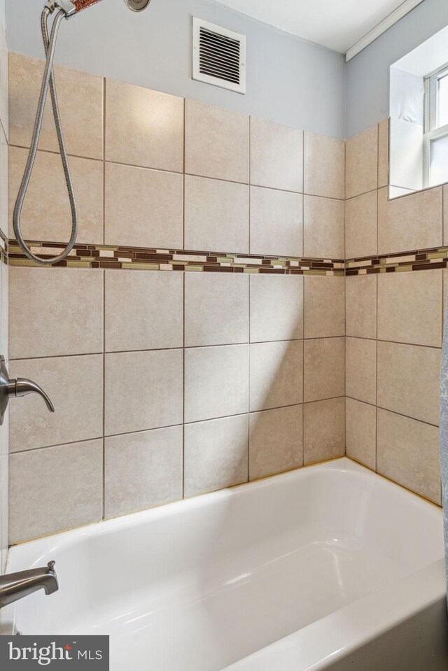 full bathroom with visible vents, a bathtub, and a shower