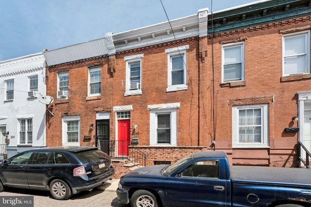 multi unit property with brick siding and cooling unit