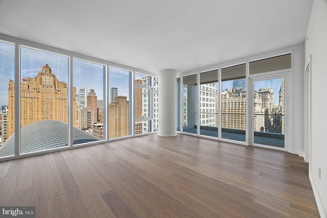 301 S Broad St Unit 1901-2, Philadelphia, PA 19107 - empty room with a city view, expansive windows, and wood finished floors