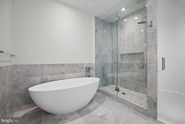 301 S Broad St Unit 1901-2, Philadelphia, PA 19107 - full bath with a freestanding bath, a shower stall, tile walls, and marble finish floor
