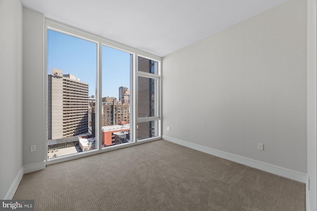 301 S Broad St Unit 1901-2, Philadelphia, PA 19107 - carpeted empty room featuring a city view and baseboards