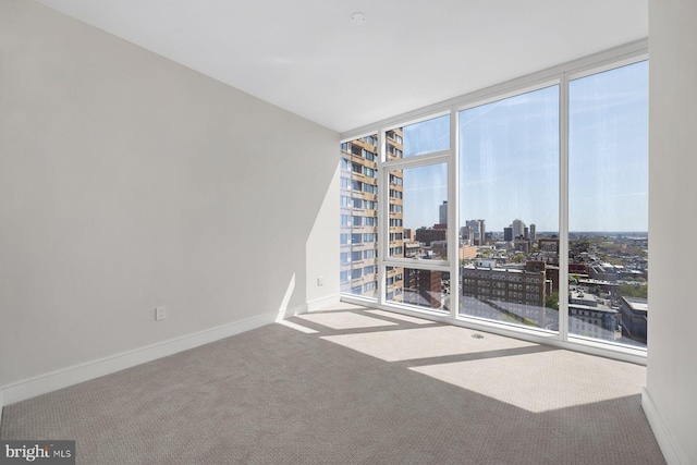 301 S Broad St Unit 1901-2, Philadelphia, PA 19107 - spare room with carpet, baseboards, a view of city, and a wall of windows