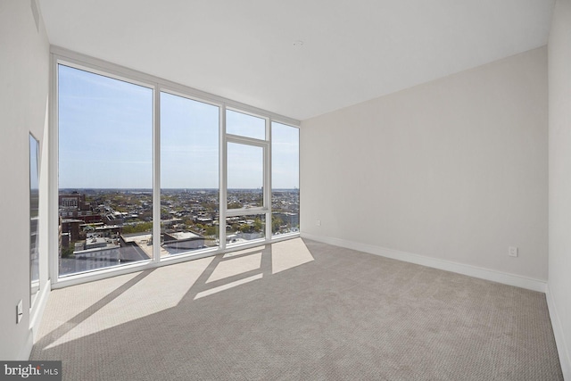 301 S Broad St Unit 1901-2, Philadelphia, PA 19107 - carpeted spare room featuring a view of city, expansive windows, and baseboards