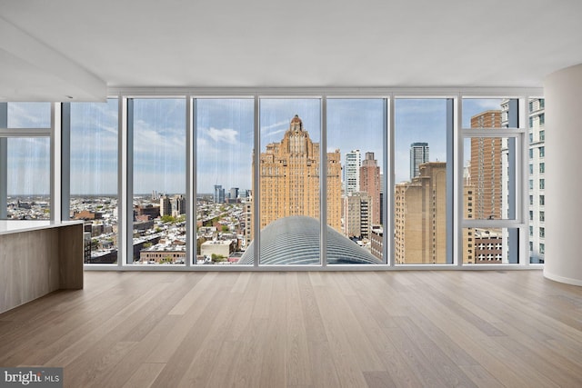 301 S Broad St Unit 1901-2, Philadelphia, PA 19107 - unfurnished room with wood finished floors, floor to ceiling windows, and a healthy amount of sunlight