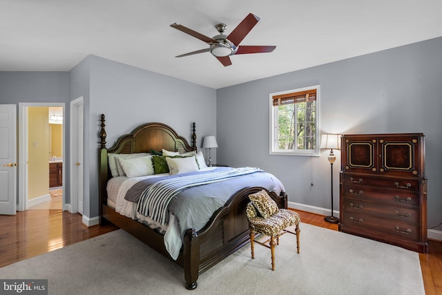 bedroom with wood finished floors, ceiling fan, and baseboards
