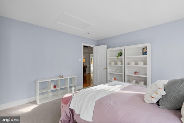 bedroom featuring attic access, carpet flooring, and baseboards